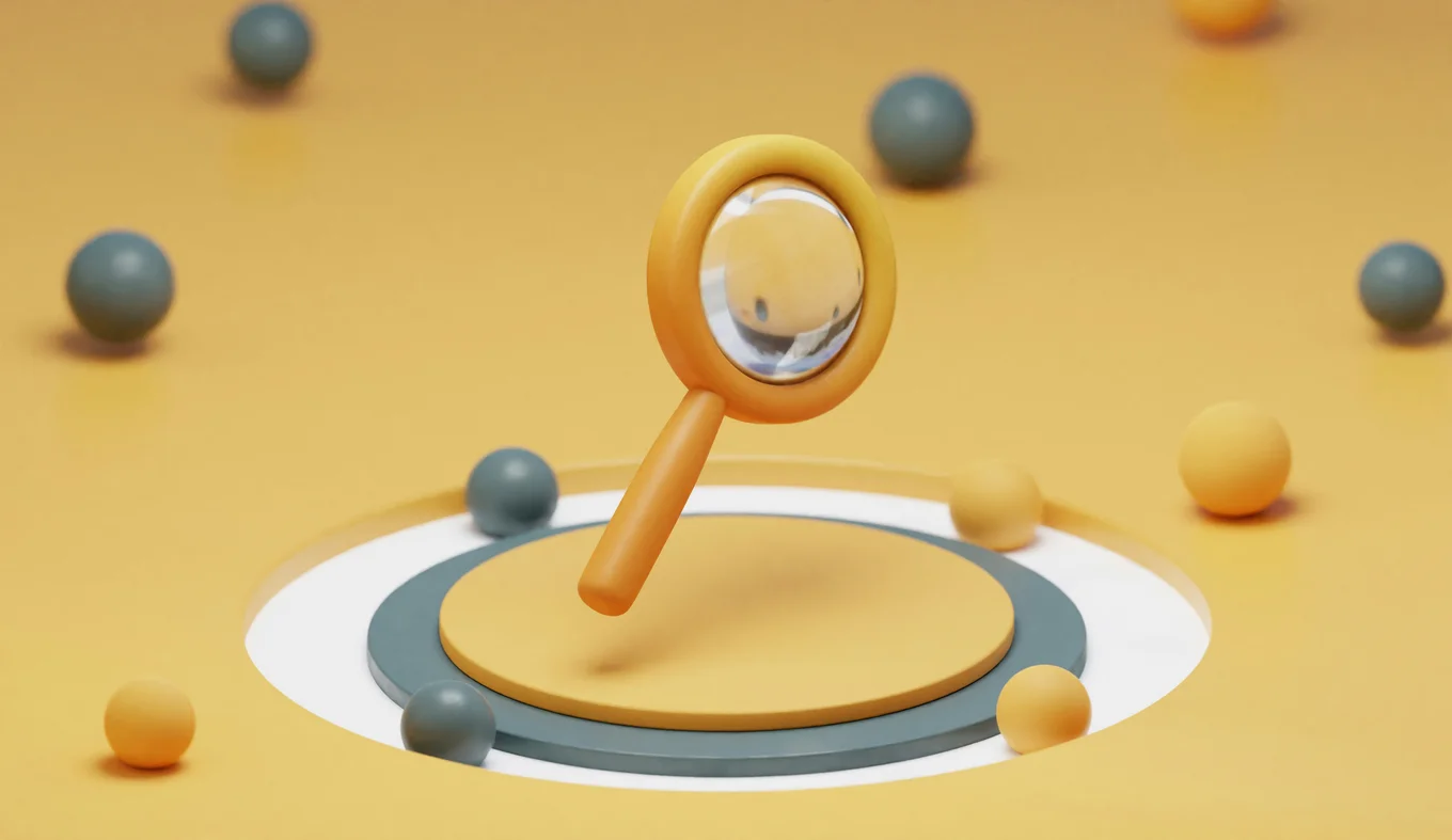 Yellow magnifying glass and spheres on orange background.